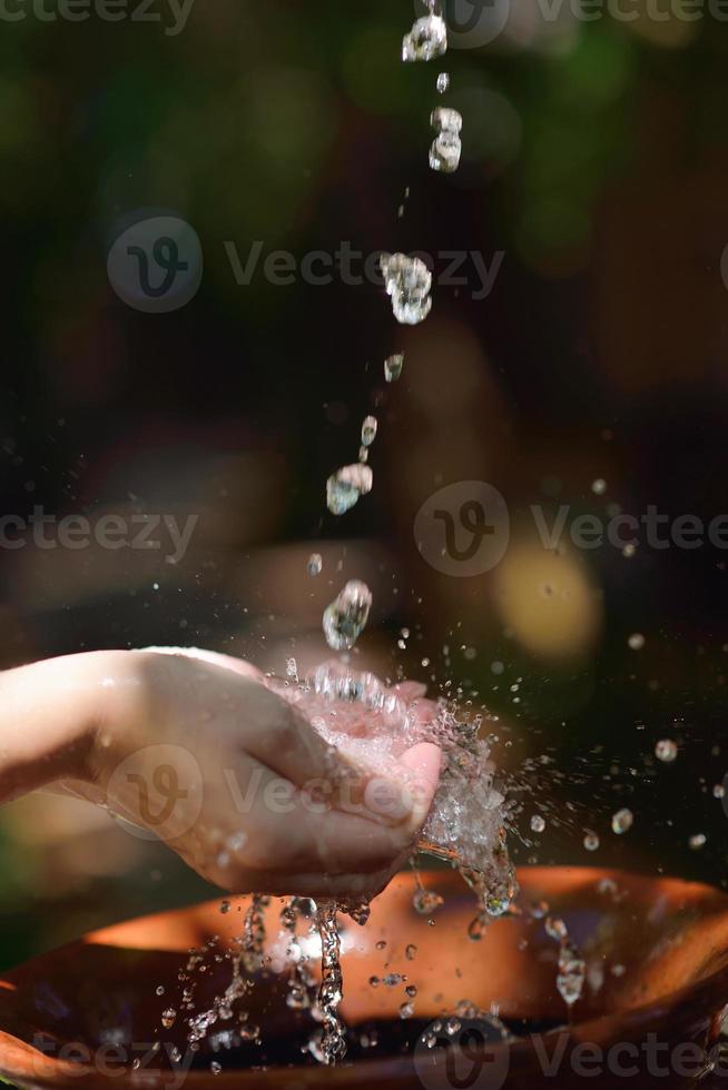 splashing fresh water on woman hands photo