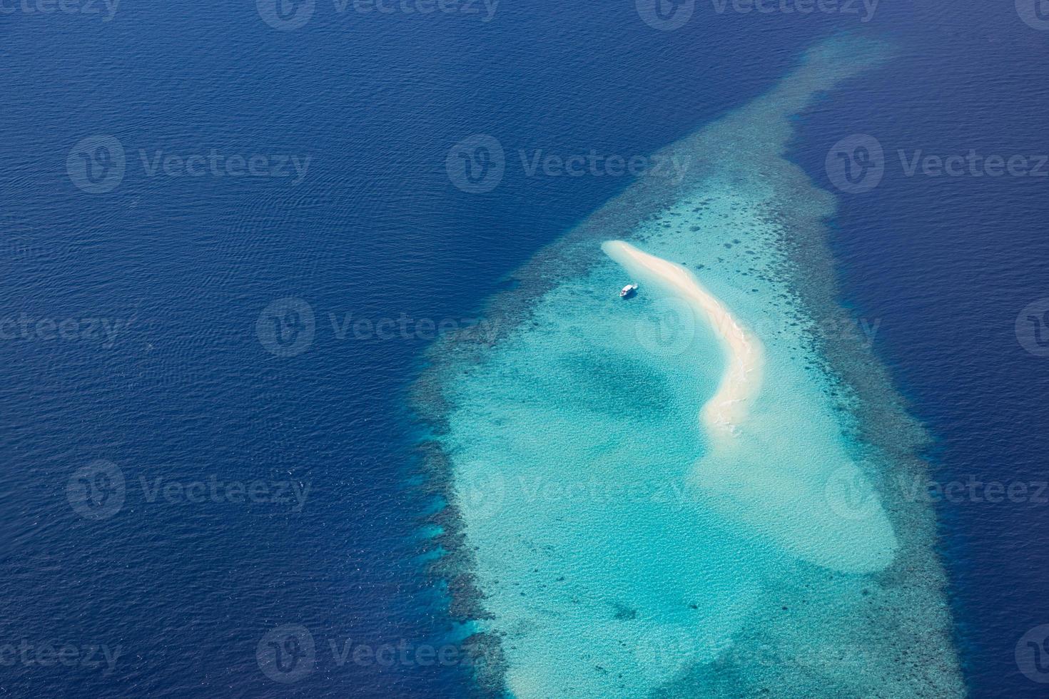 Aerial picture of turquoise blue tropical ocean lagoon, white sandy beach, sandbank coral reef shallow water with a boat. Nature perfection in Maldives sea. Luxury life experience, peaceful landscape photo