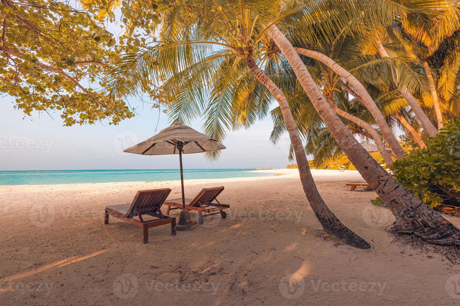 Amazing romantic beach. Chairs on the sandy beach near the sea. Summer holiday vacation concept for tourism. Tropical island landscape. Tranquil shore scenery, relax seaside horizon, palm leaves photo