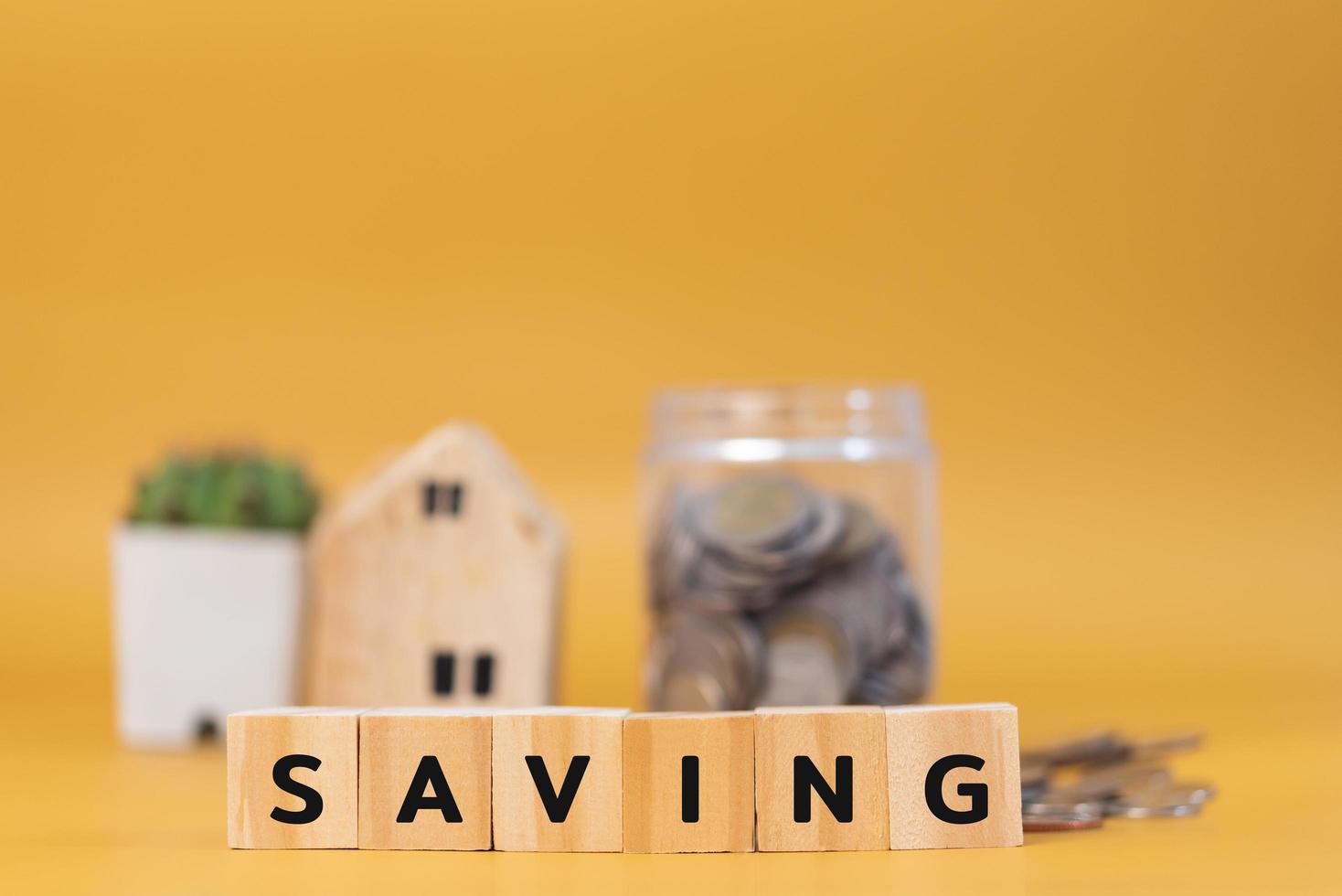 wood cube block saving on yellow background.Business finance investment economy banking concept. photo