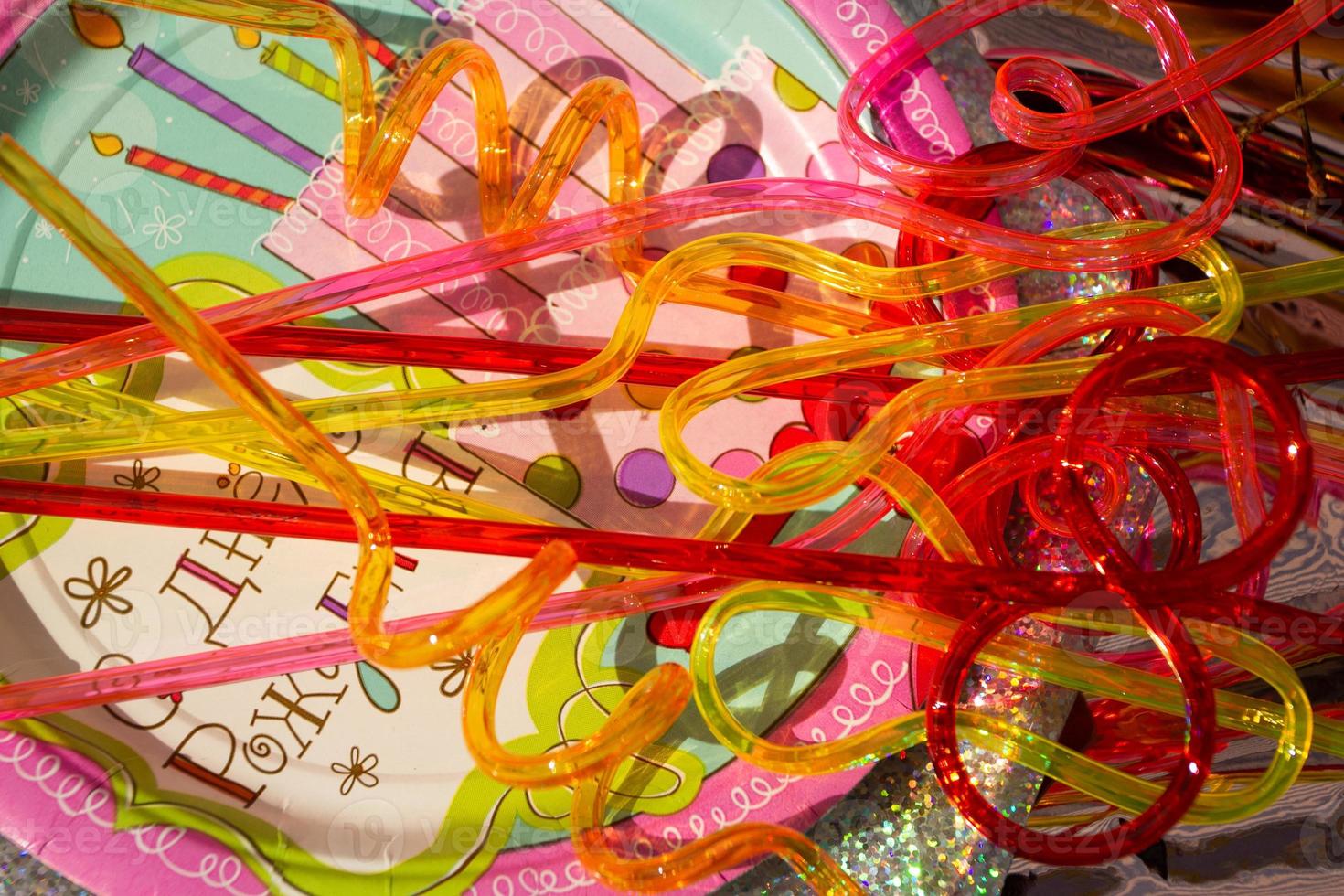 Colorful cocktail tubes lying on a paper plate. photo