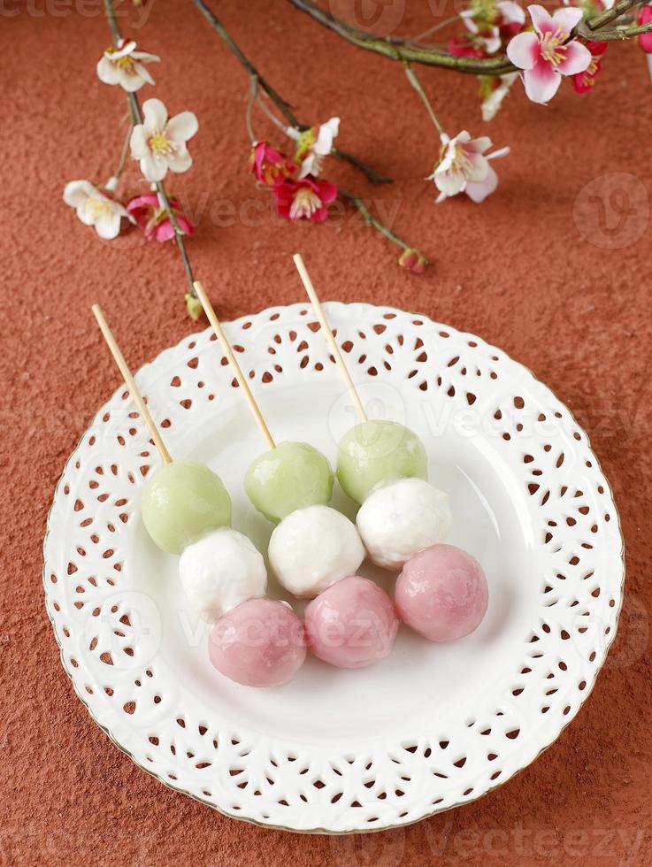 Sanshoku Dango, Japanese Three Colored Mochi Dumplings Skewer. photo
