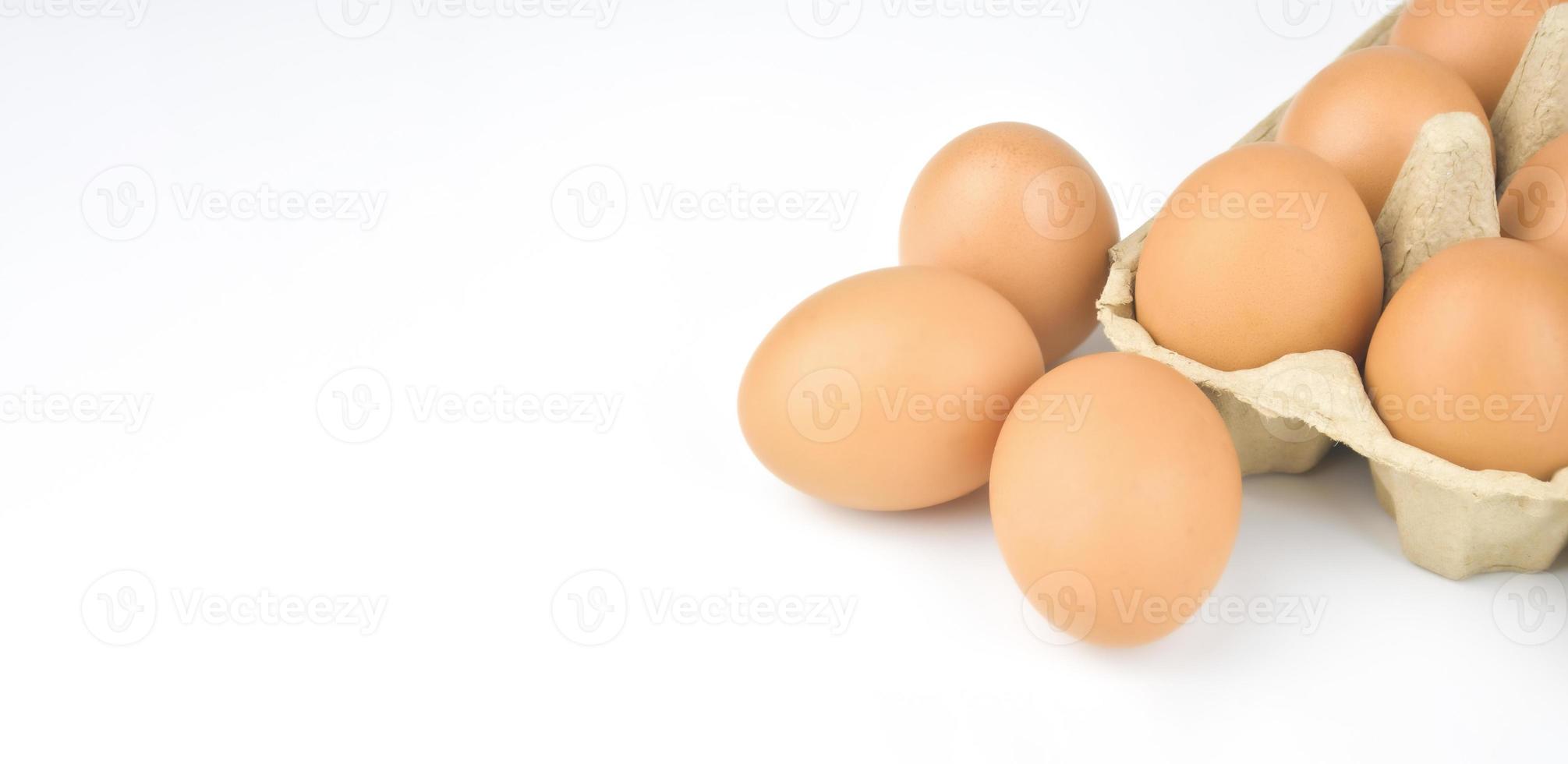 Fresh and appetizing eggs are packed in egg cartons. put on a white background photo