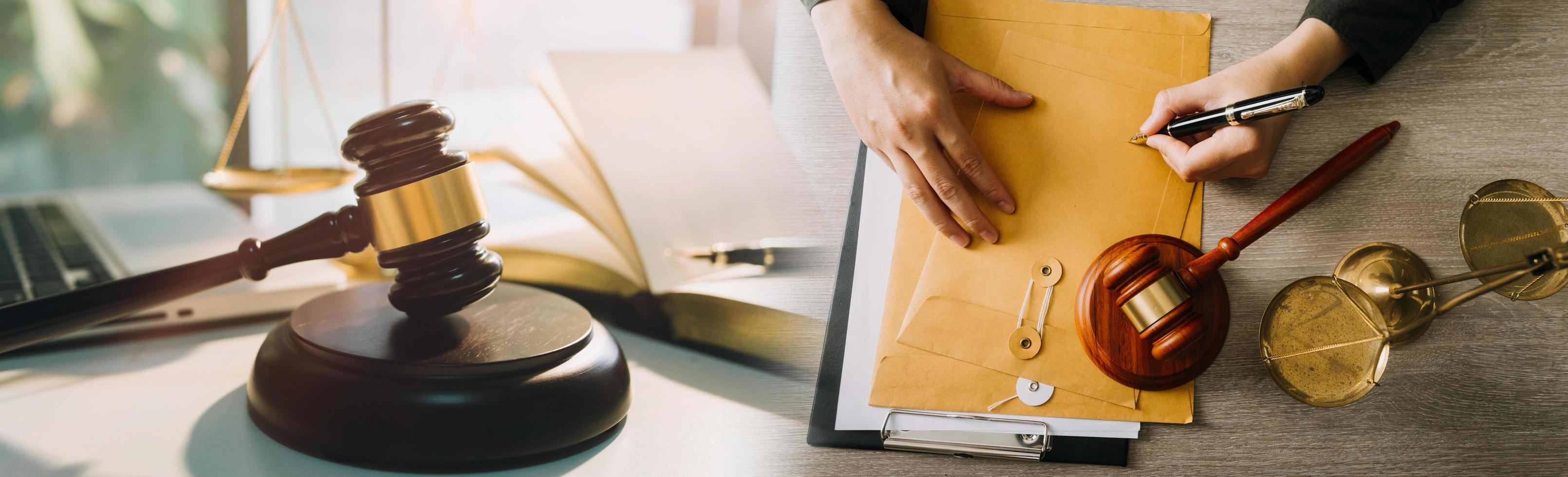 Justice and law concept. Gavel on sounding block in hand's Male judge at a courtroom, working with document law books, report the case on table in modern office. photo