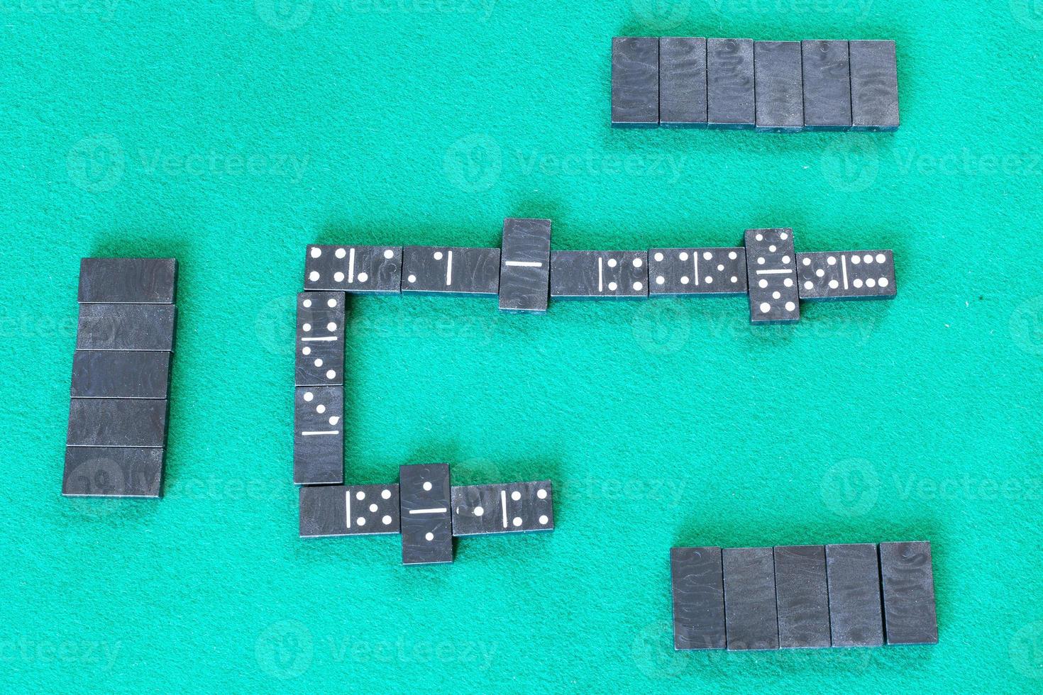 gameplay of dominoes board game with black tiles photo