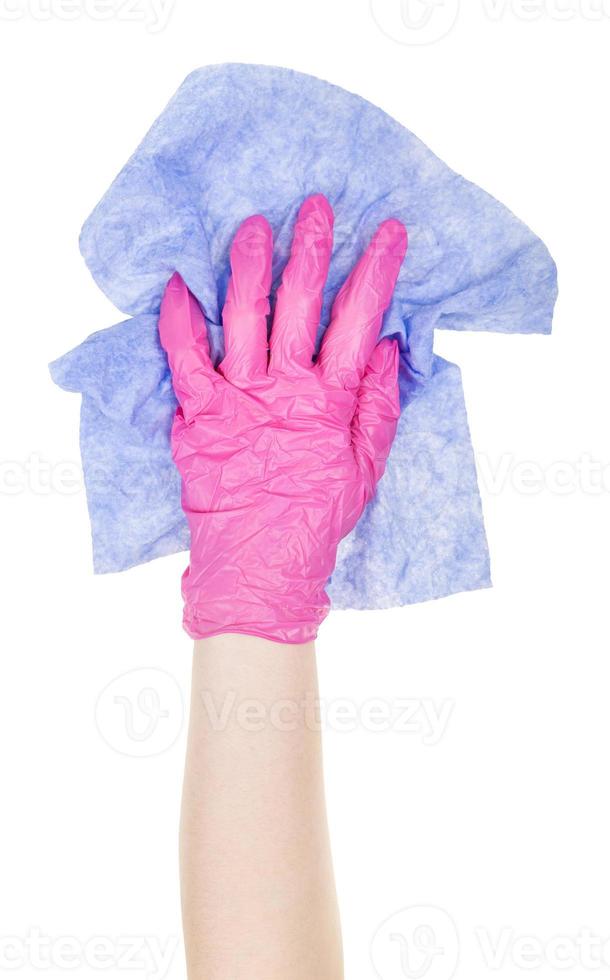 hand in pink glove wipes with crumpled blue rag photo