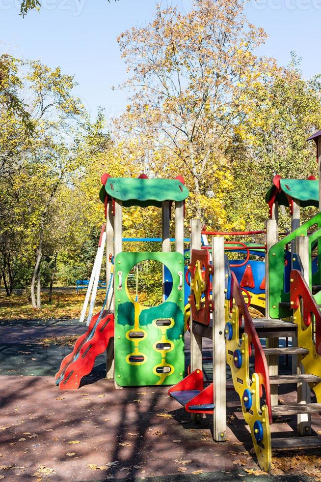 colorful wooden rides, slides on playground photo