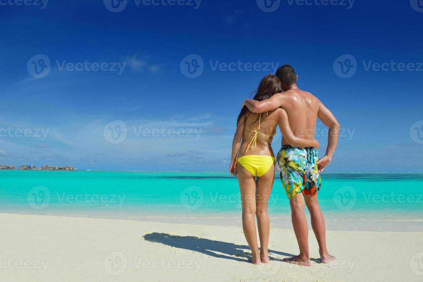 happy young  couple enjoying summer on beach photo