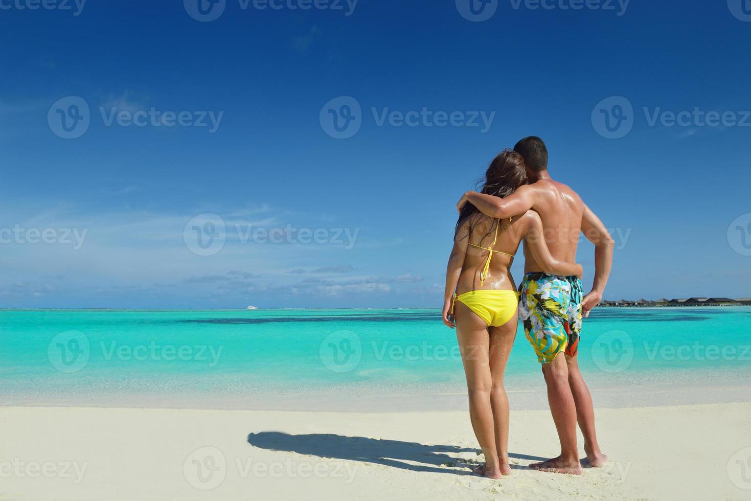 happy young  couple enjoying summer on beach photo