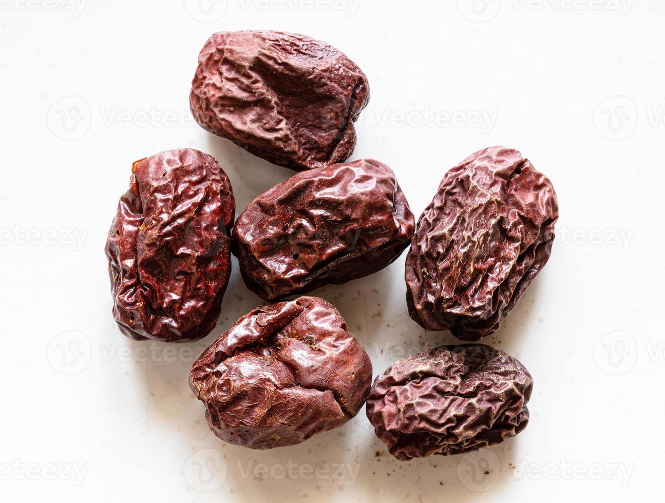 several dried jujube chinese date fruits on gray photo