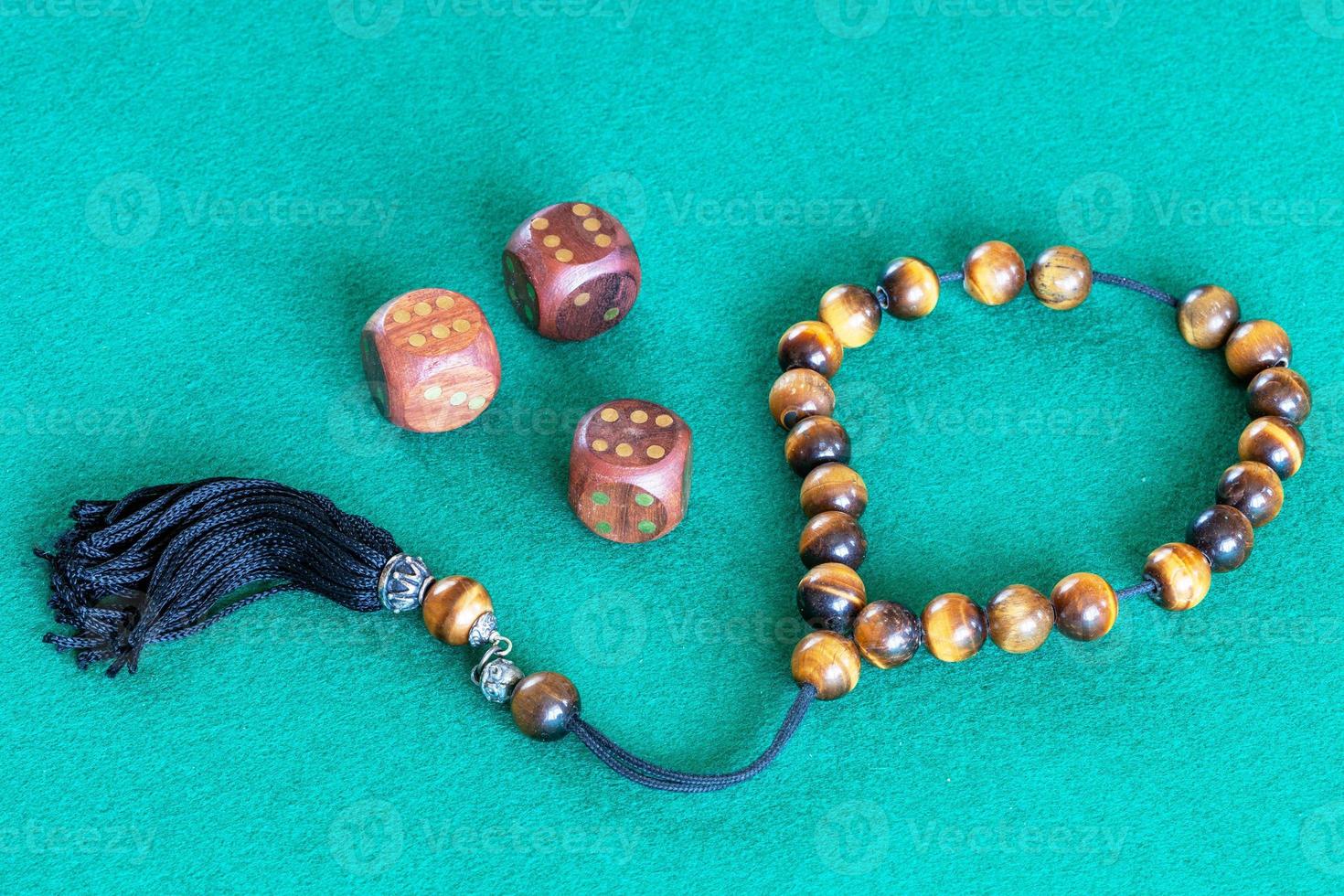 worry beads and three wooden dices with six points photo