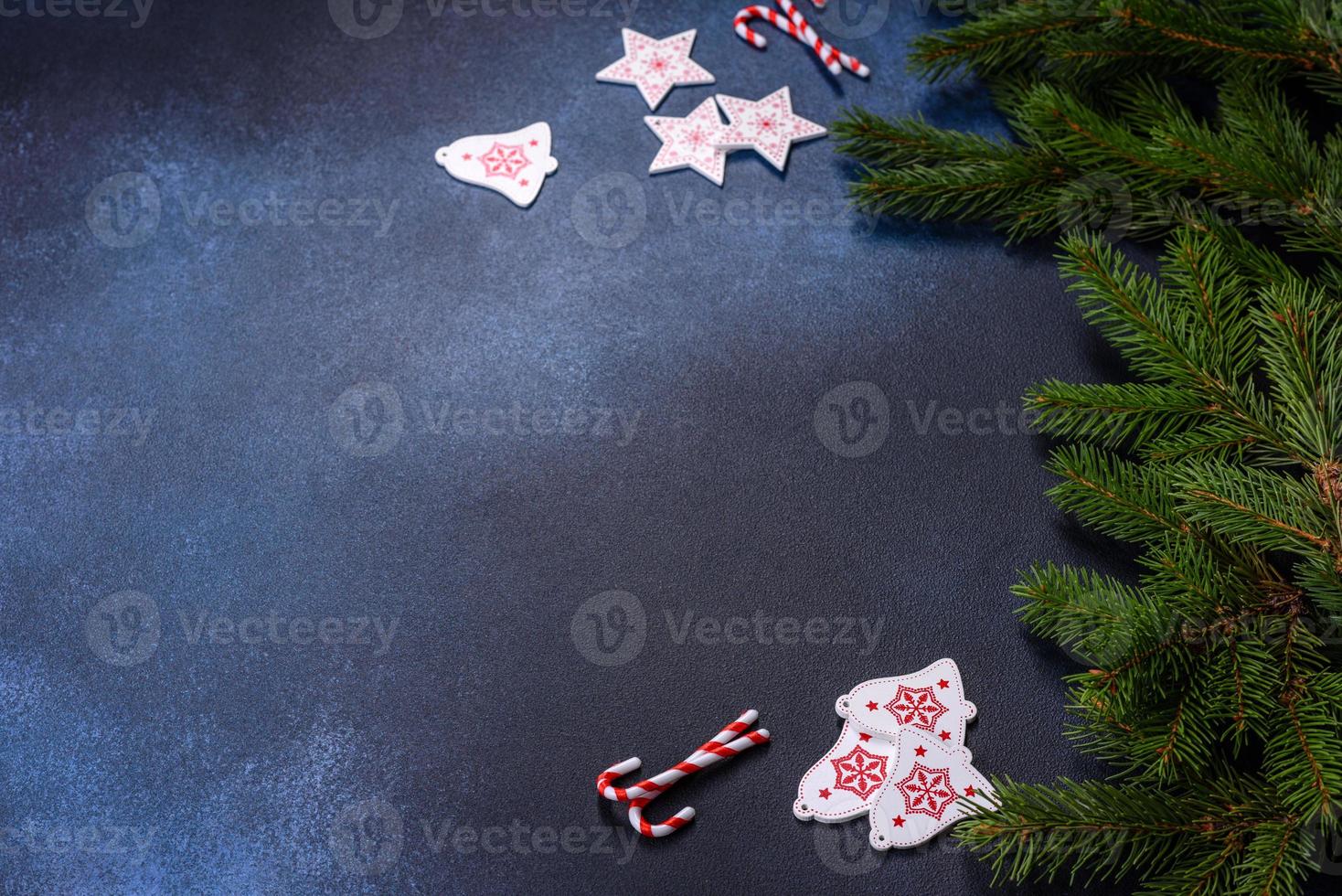 Christmas candy with decorations on dark table photo