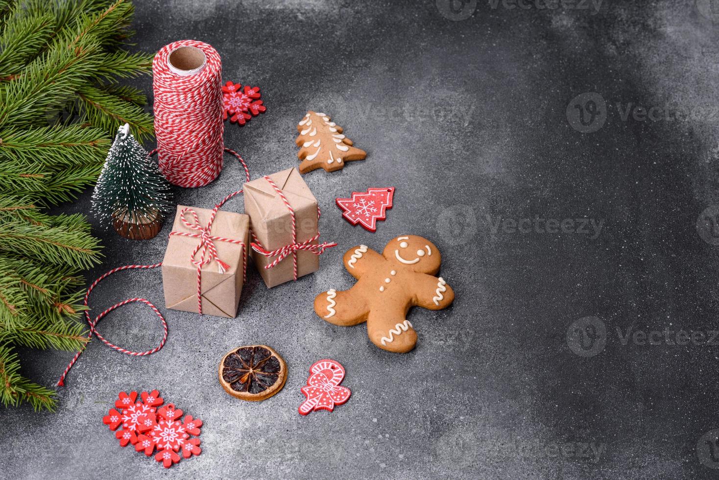 Gingerbread, Christmas tree decorations, dried citrus fruits on a gray concrete background photo