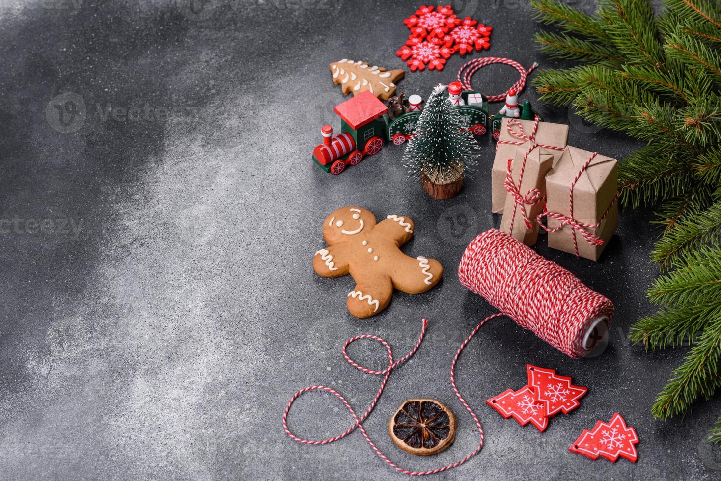 Gingerbread, Christmas tree decorations, dried citrus fruits on a gray concrete background photo