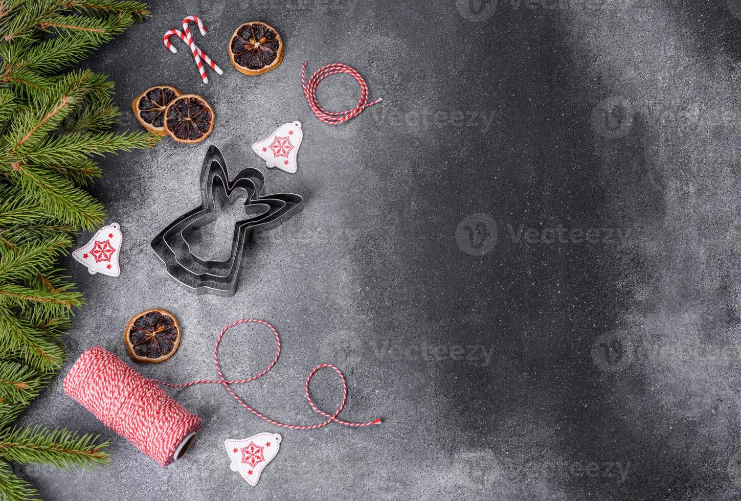 Gingerbread, Christmas tree decorations, dried citrus fruits on a gray concrete background photo