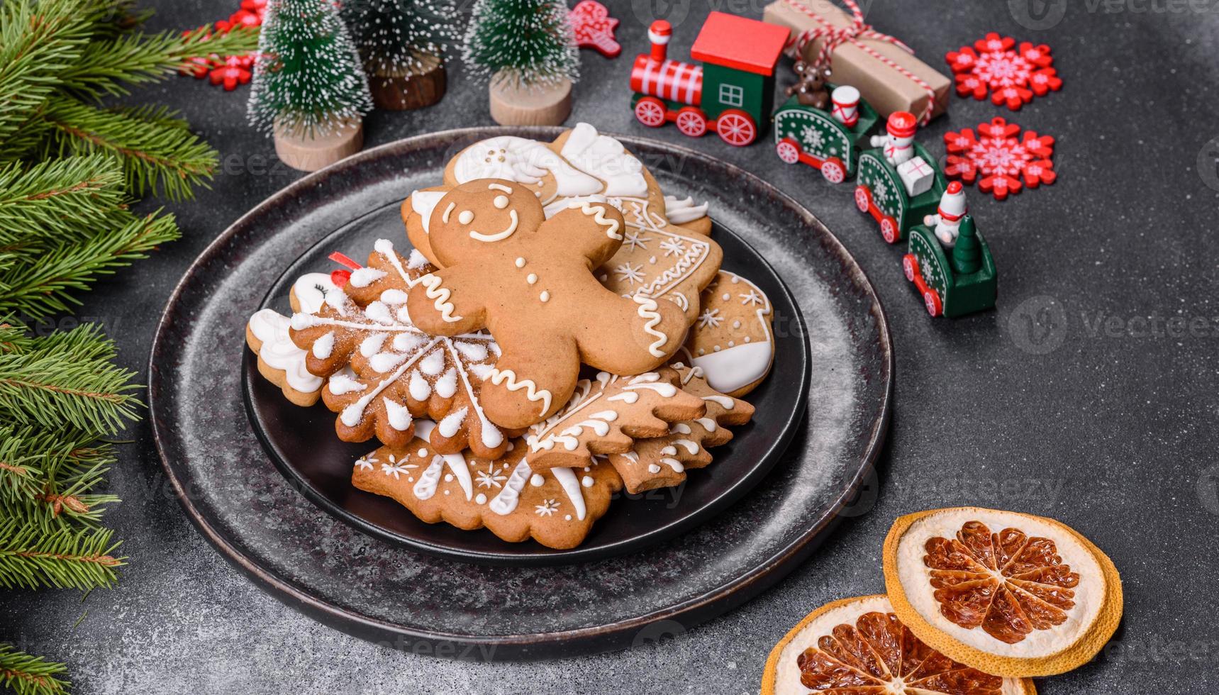 Gingerbread, Christmas tree decorations, dried citrus fruits on a gray concrete background photo