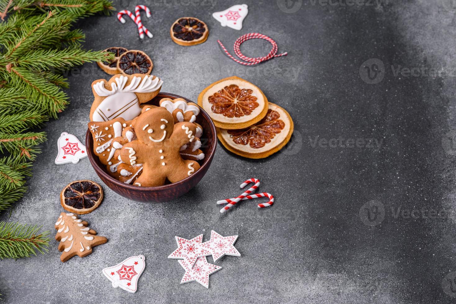 Gingerbread, Christmas tree decorations, dried citrus fruits on a gray concrete background photo