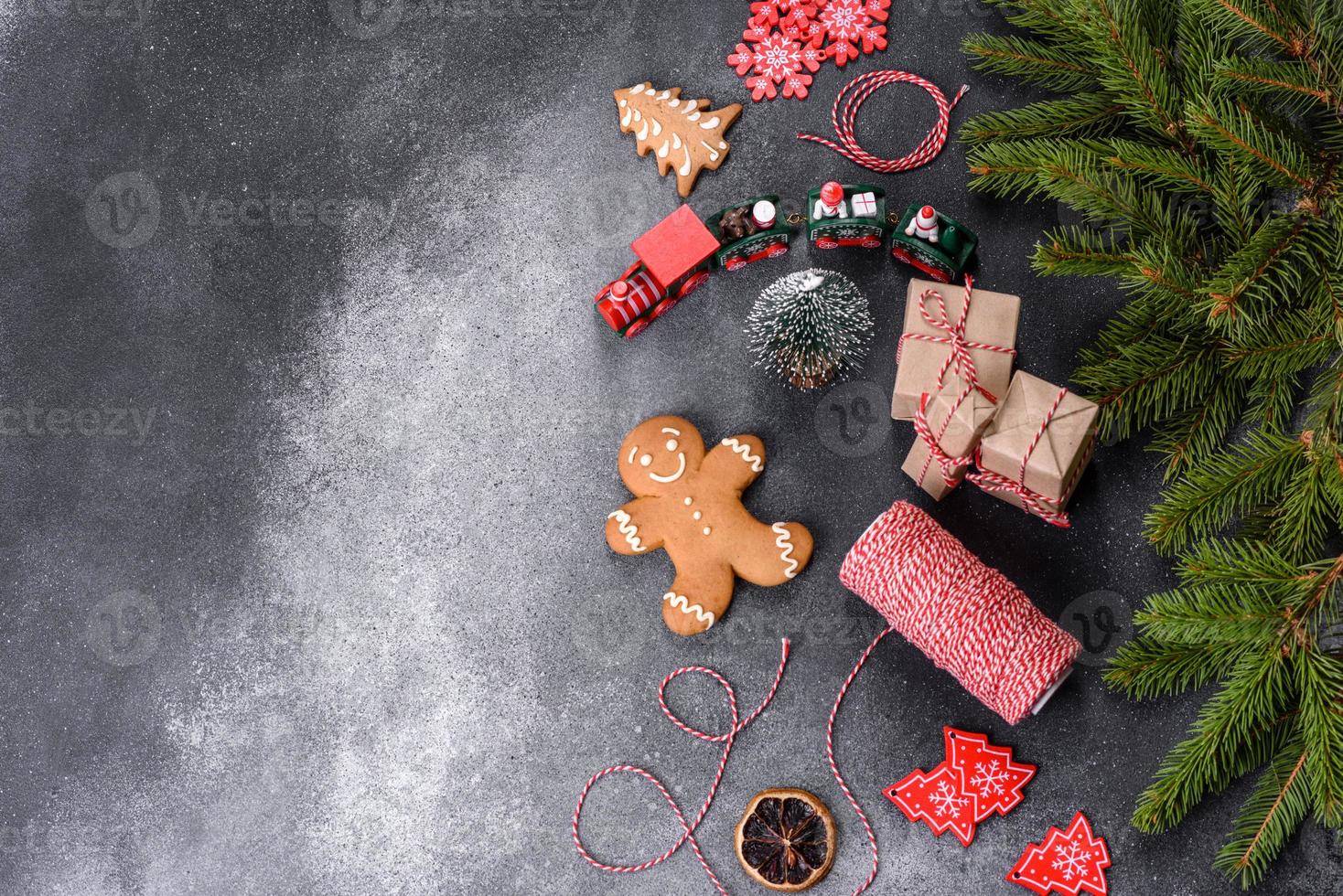 pan de jengibre, adornos de árboles de Navidad, cítricos secos sobre un fondo de hormigón gris foto