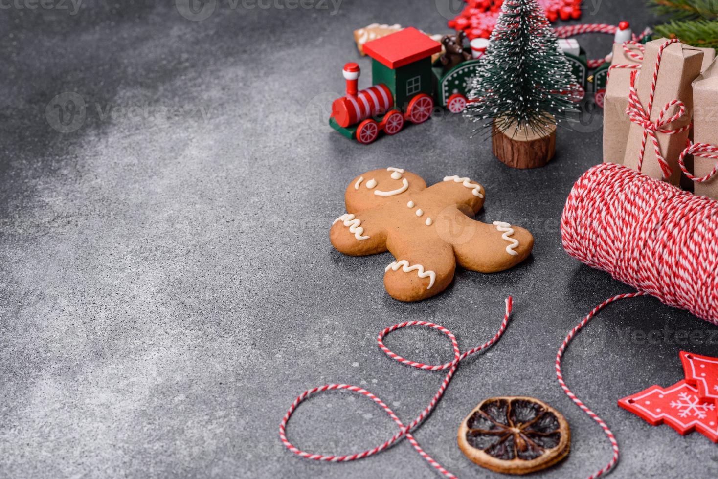 Gingerbread, Christmas tree decorations, dried citrus fruits on a gray concrete background photo