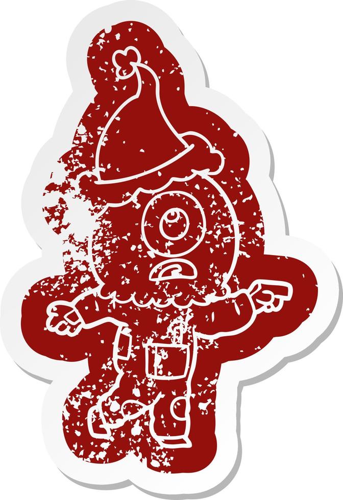cartoon distressed sticker of a cyclops alien spaceman pointing wearing santa hat vector