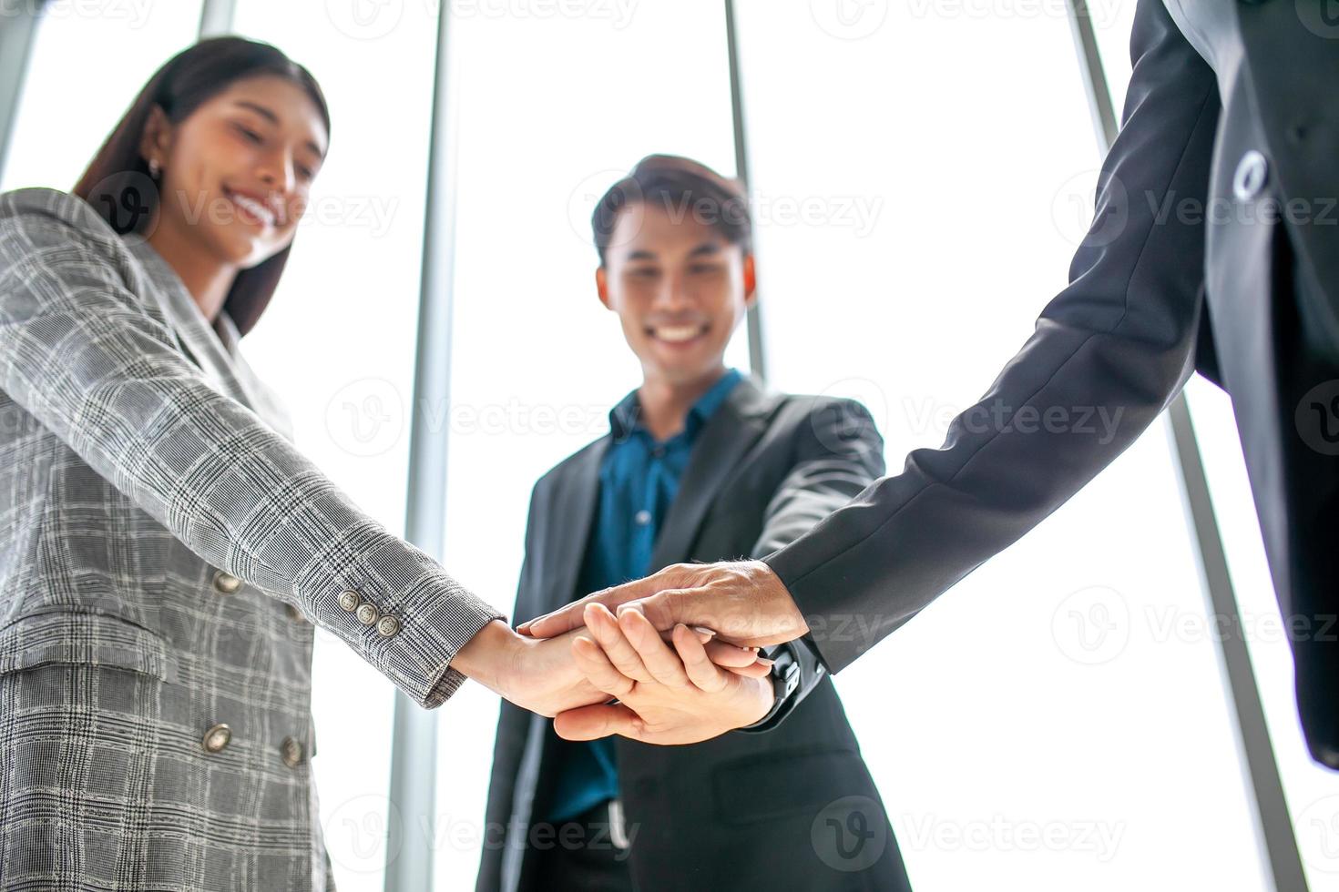 Teamwork Deal Cooperation Partnership business people giving hi-five before work in the office, touch hands for unity group to succuss business. photo