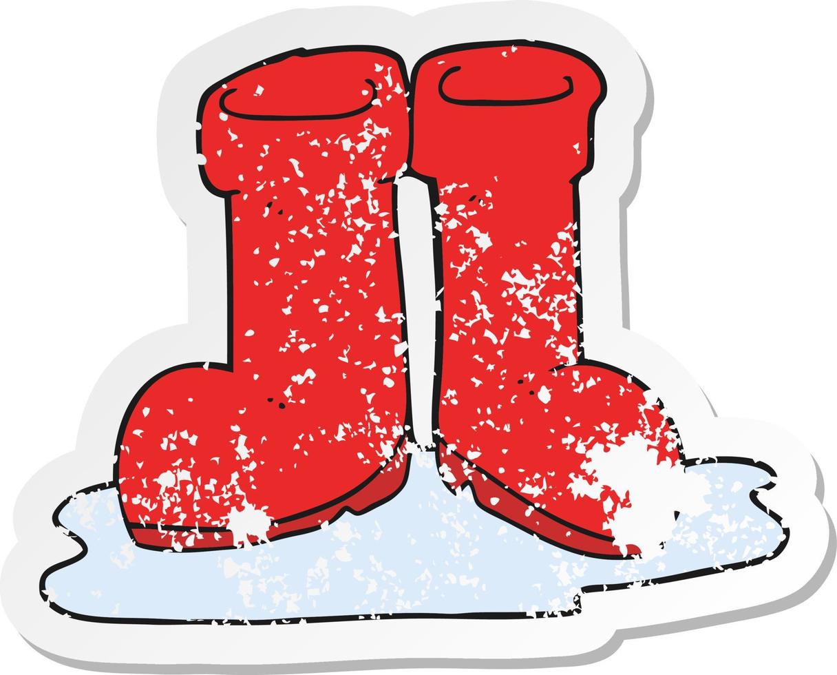 retro distressed sticker of a cartoon wellington boots in puddle vector