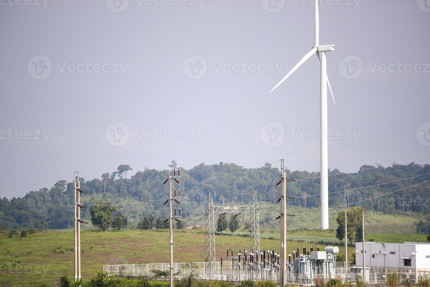 wind turbine farm on hill photo