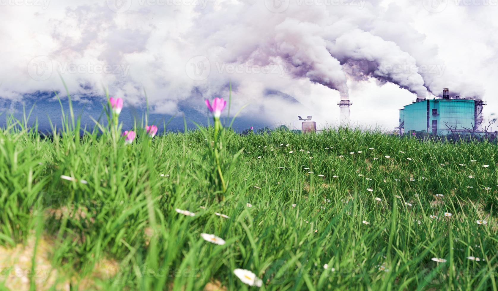 comparing air pollution and factory with green grass field with flower, environment safe and earth protection concept photo