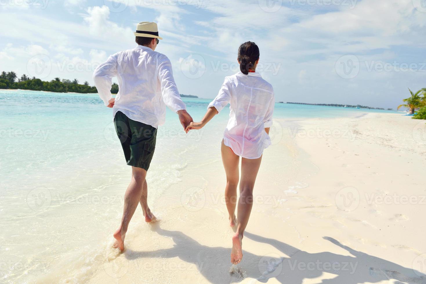 happy young couple have fun on beach photo