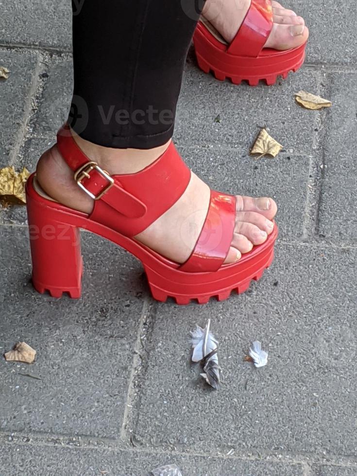 Female legs in sandals. Summer street fashion. photo