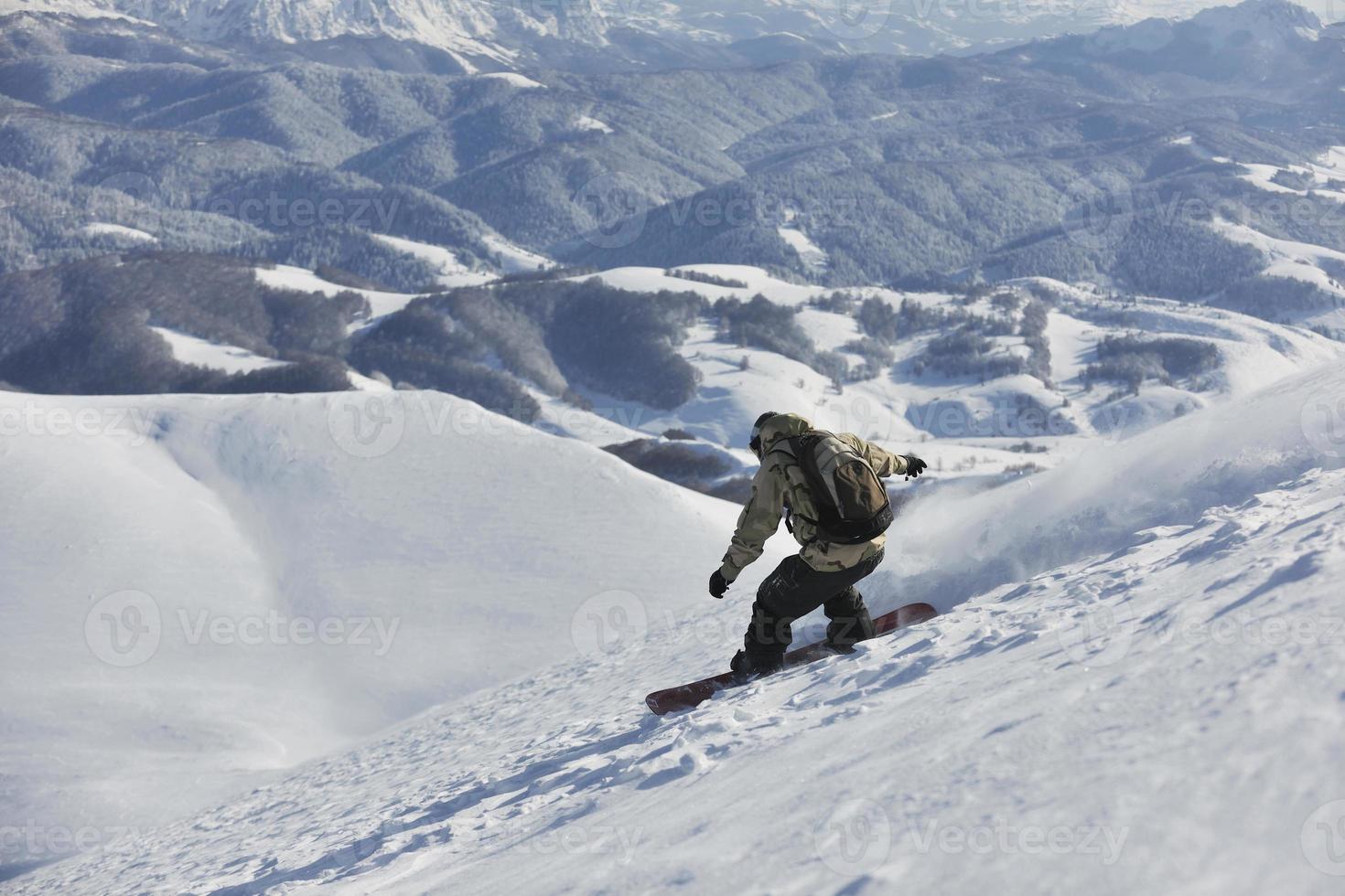 freestyle snowboarder jump and ride photo