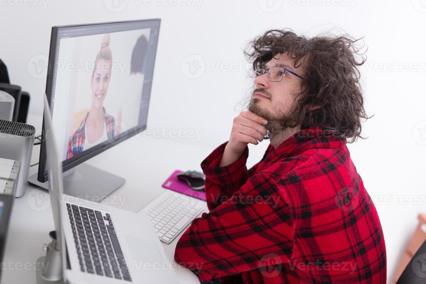 graphic designer in bathrobe working at home photo