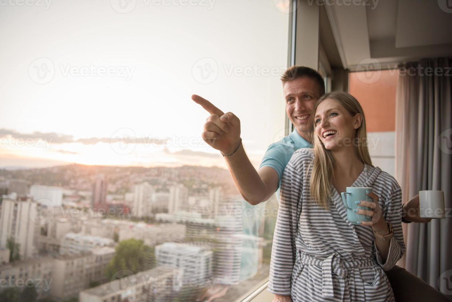 young couple enjoying evening coffee by the window photo