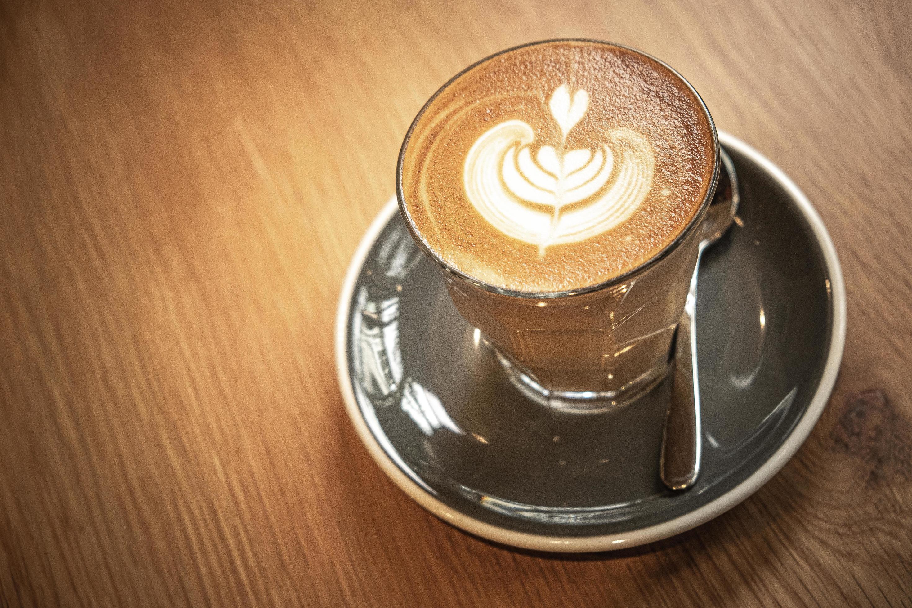 A cup of coffee latte top view with leaf shape foam 10768256 Stock