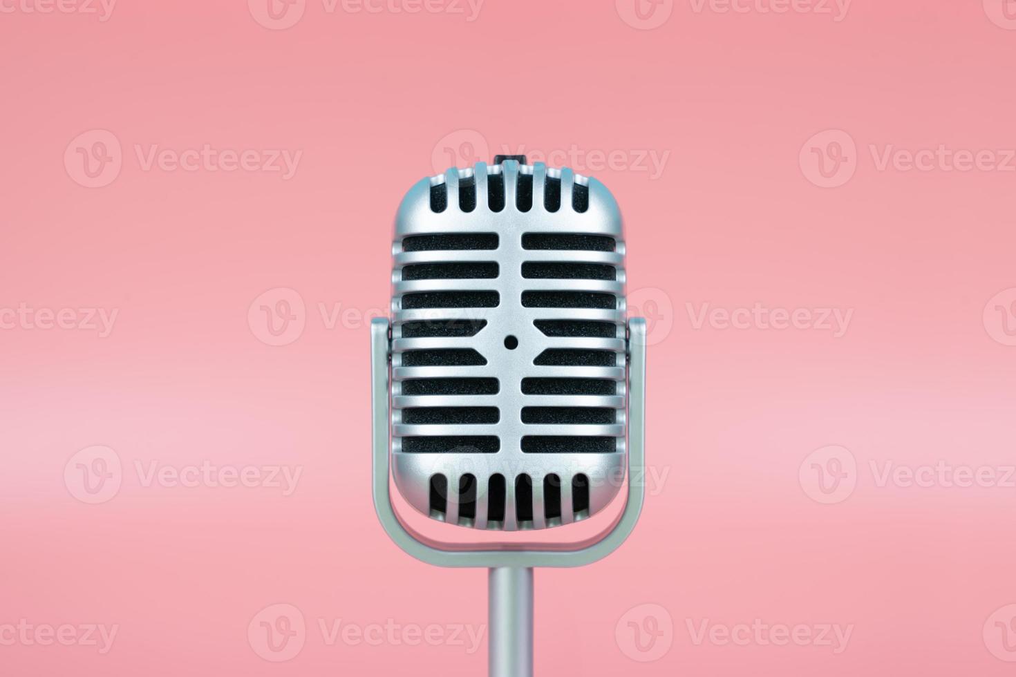 Retro microphone with copy space on pink background photo