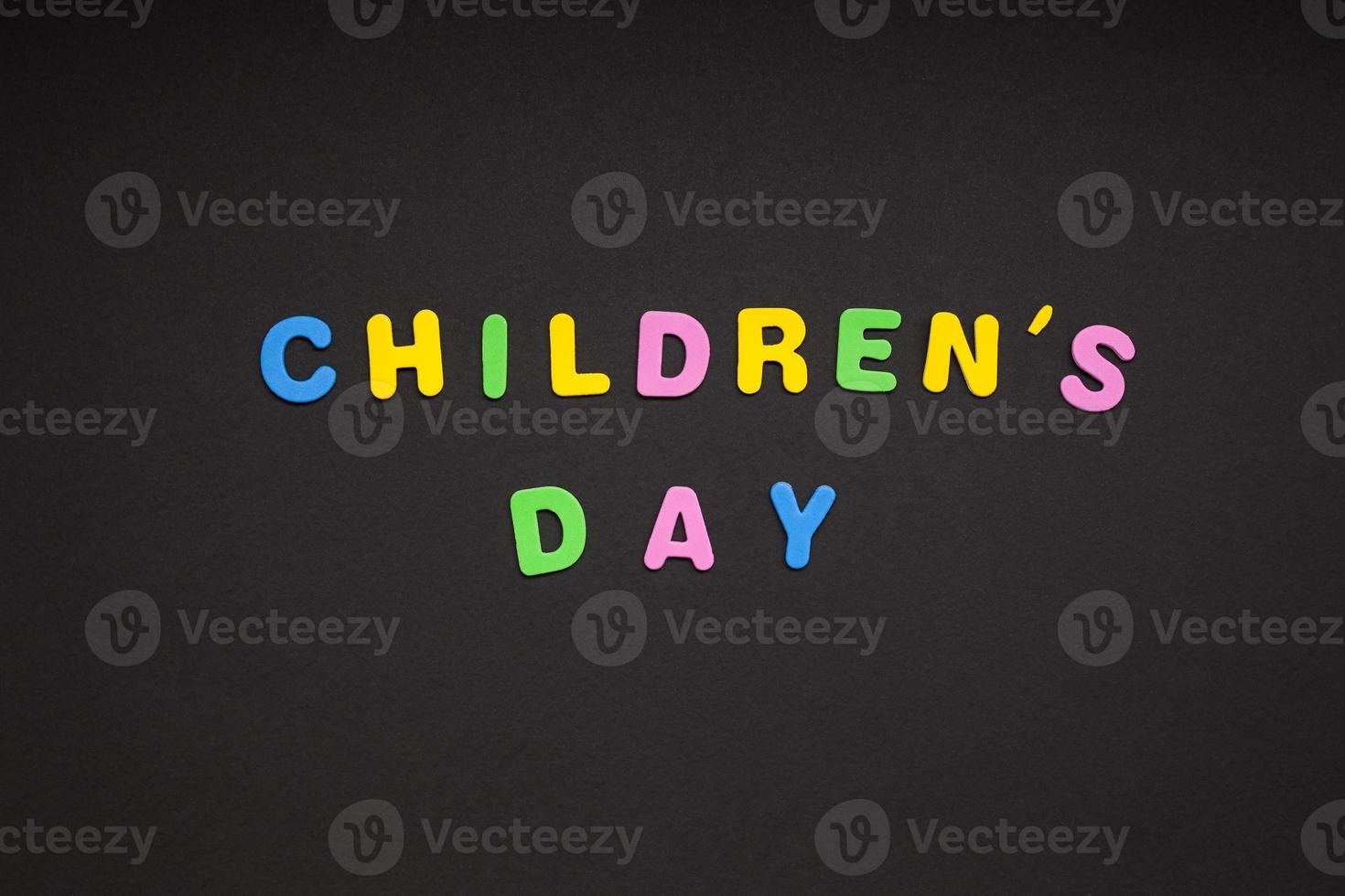 Children's day writing on black paper background photo