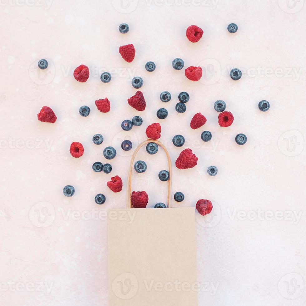 Shopping composition berries flying from bag photo