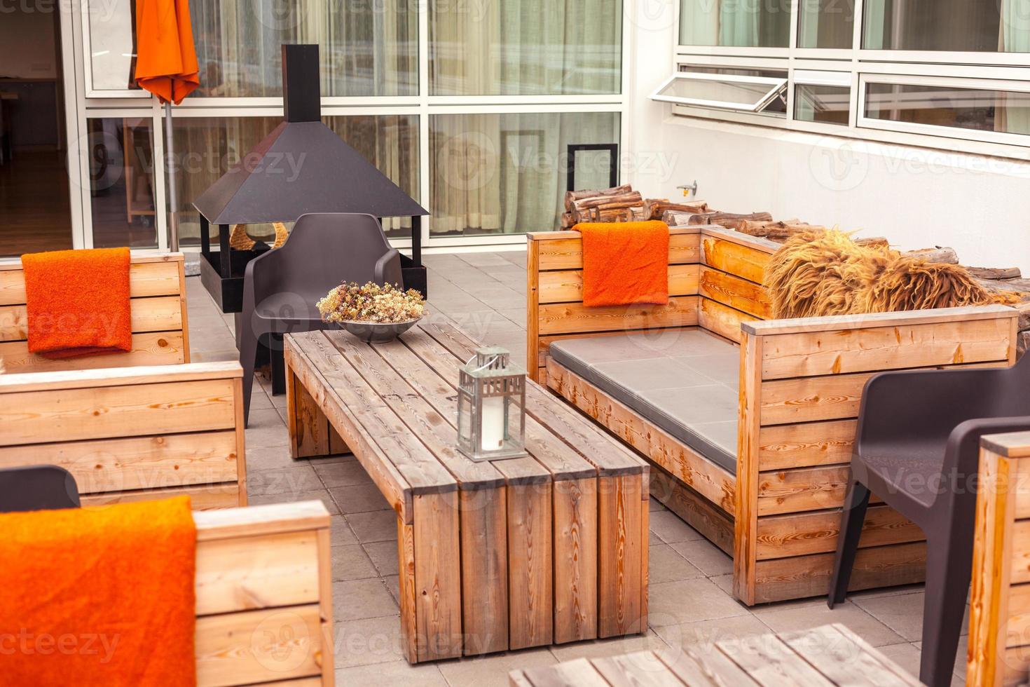 Outdoor restaurant terrace with wooden furniture photo