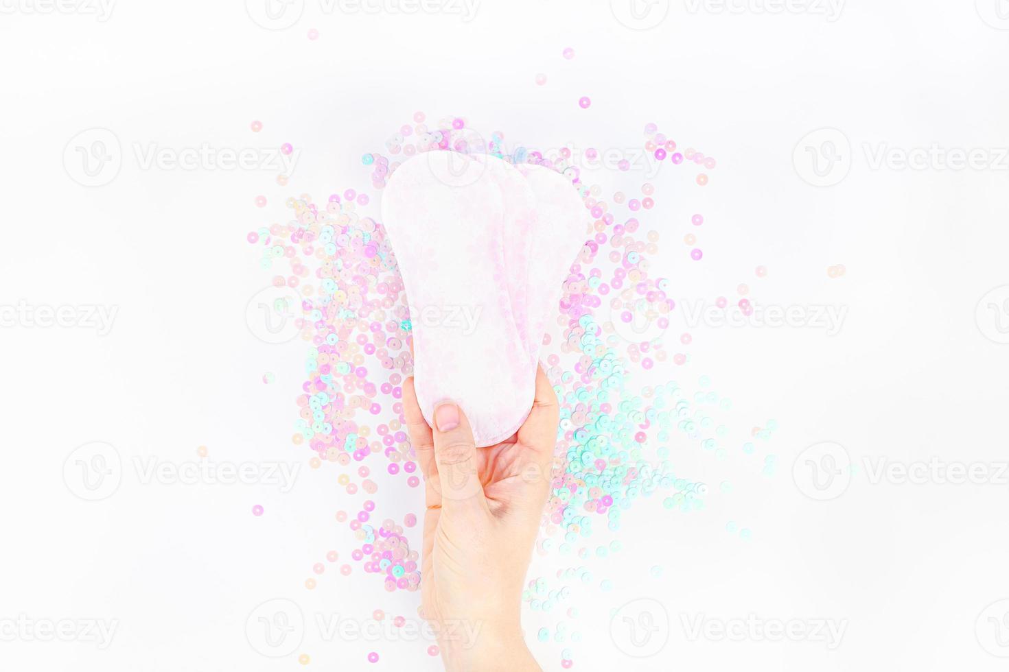 Woman hand holding daily sanitary napkins photo