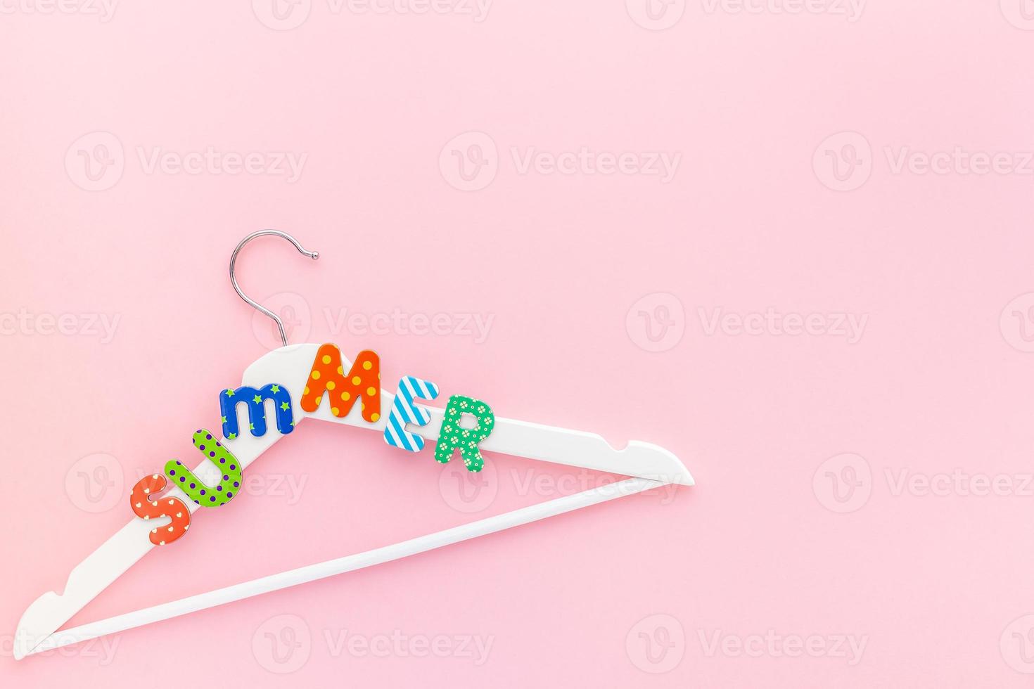 White hangers with summer text pink background photo