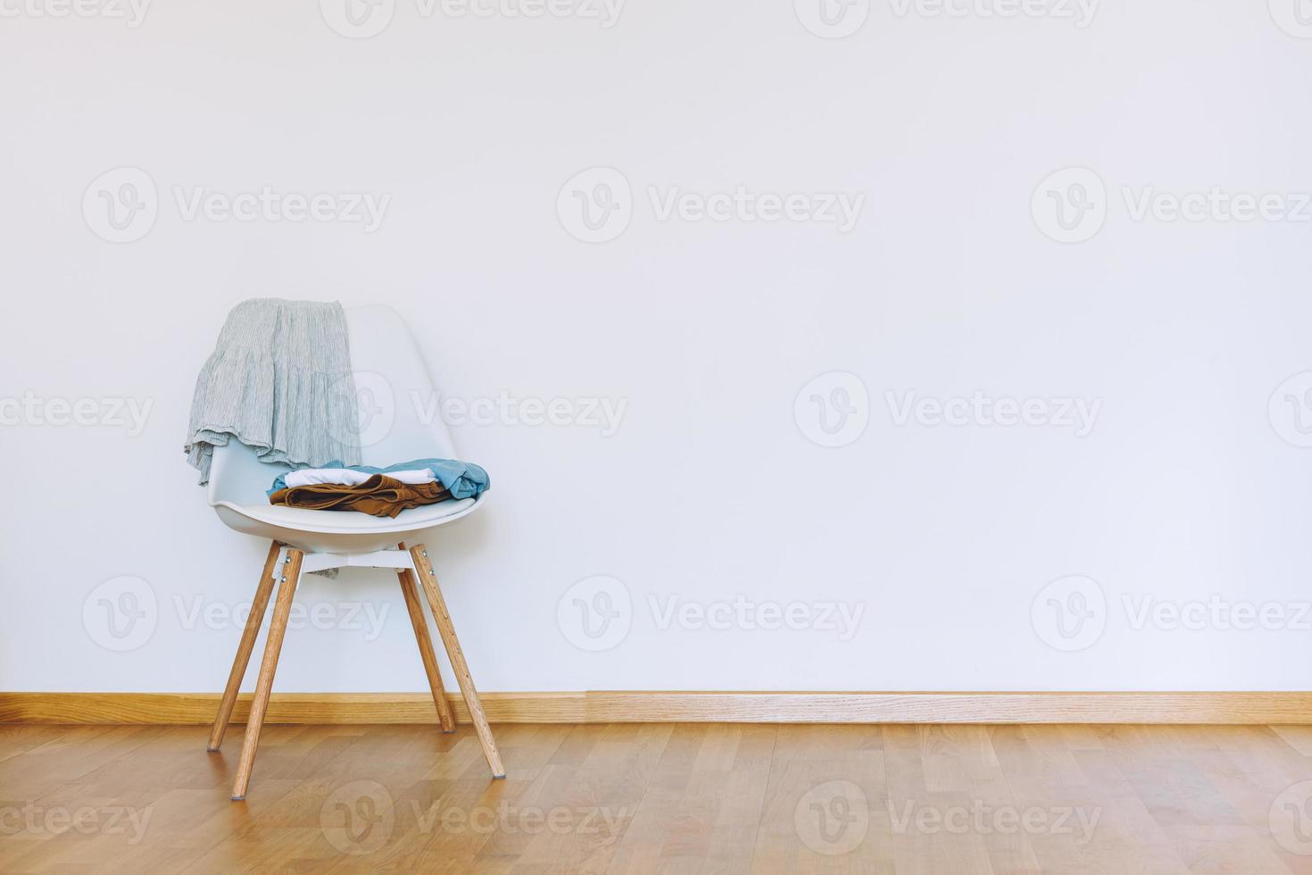 Indoors flat wall mockup with Clothes on Chair photo