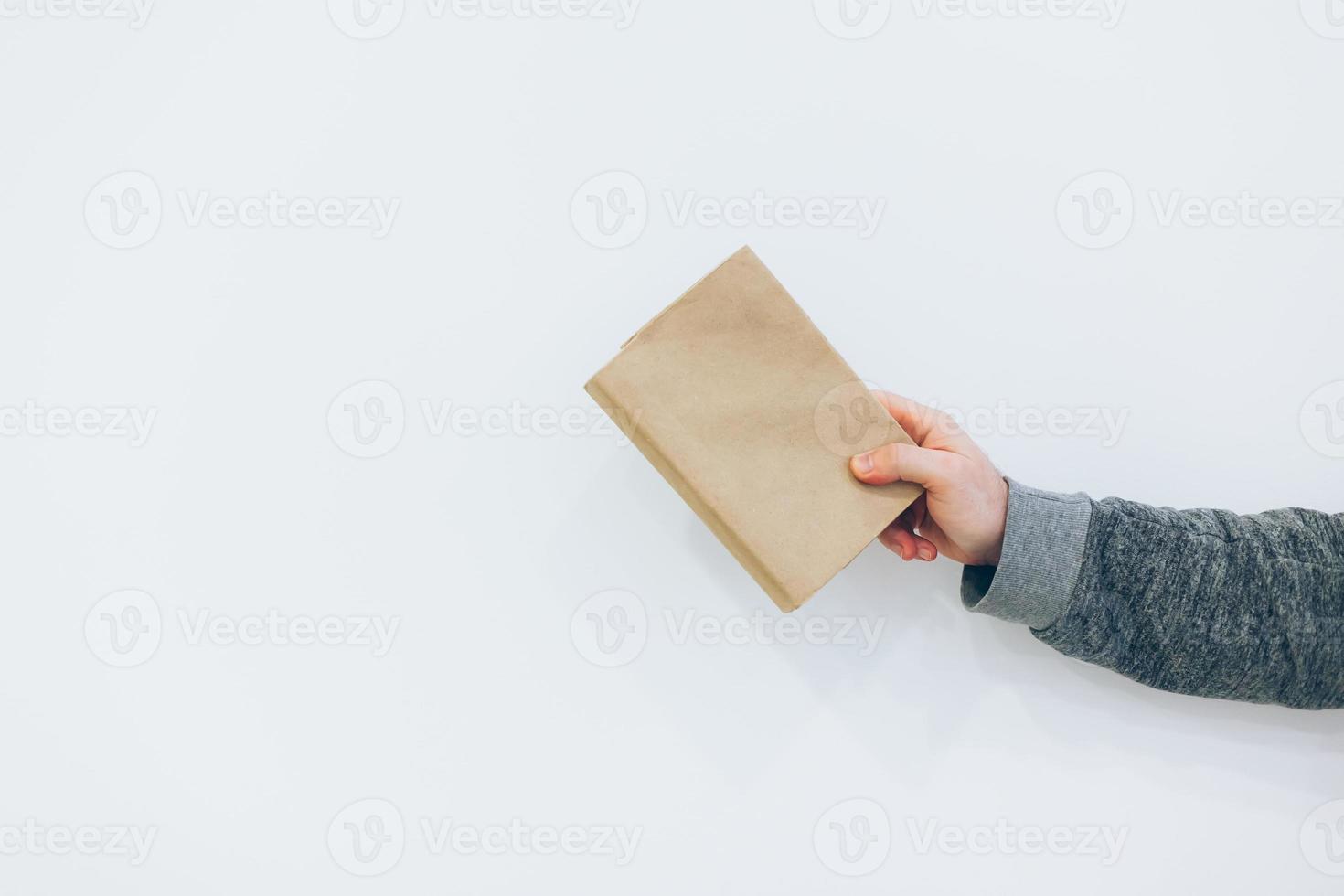 Man holding close old paper book photo