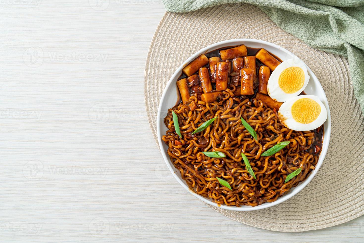 Jjajang Rabokki - Korean instant noodles or Ramyeon with Korean rice cake or Tteokbokki and egg in black bean sauce photo