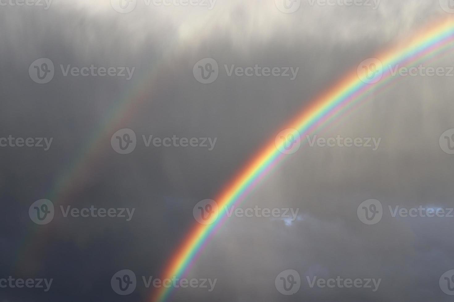 Stunning natural double rainbows plus supernumerary bows seen at a lake in northern germany photo