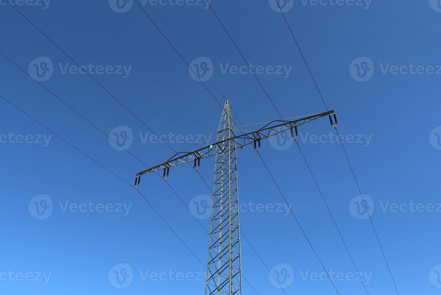 View of very large electricity pylons with high voltage cables from a moving car. photo