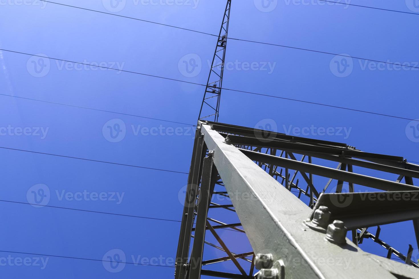 View of very large electricity pylons with high voltage cables from a moving car. photo