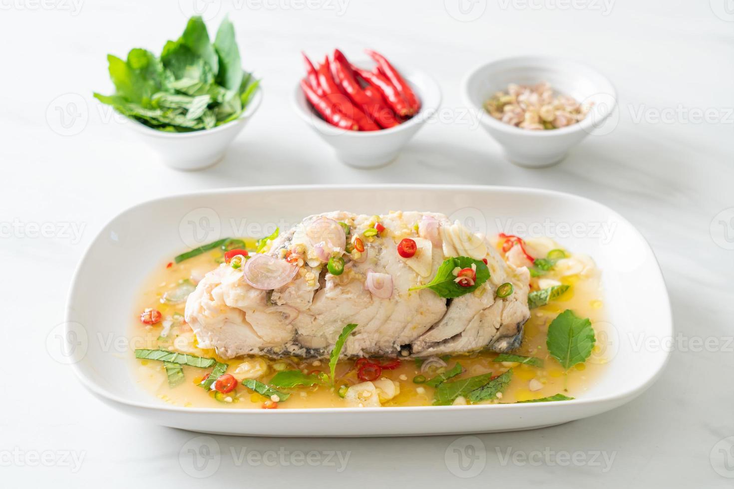 steamed sea bass fish with herbs photo