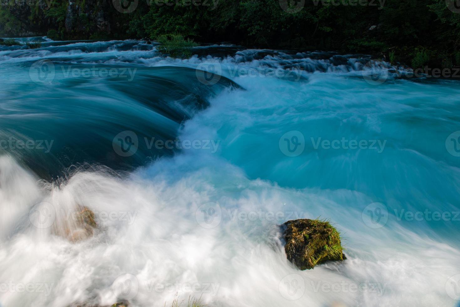 single stone in wild river photo