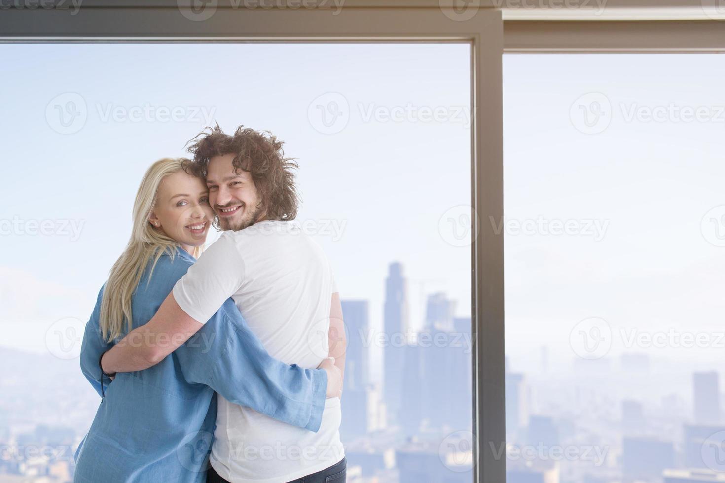 young couple enjoying morning coffee by the window photo