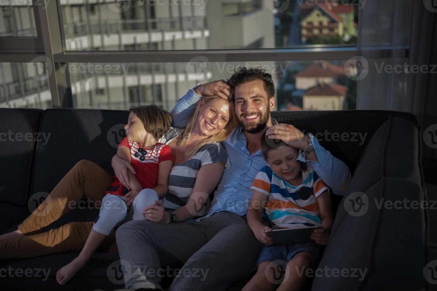 happy young couple spending time with kids at home photo